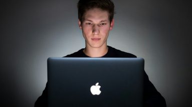 Man sitting alone in a dark room